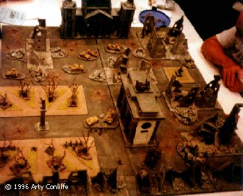 Several turns later. The Soviet assaults have successfully made it into the park and, an IS-II leading a SU-122 have made it to the foot of the Brandenburg gate. An assault squad takes cover behind the burnt out remains of a StuG III and a Tiger in the centre of the picture. Every approach is swept by MG fire and snipers pick off the unwary.